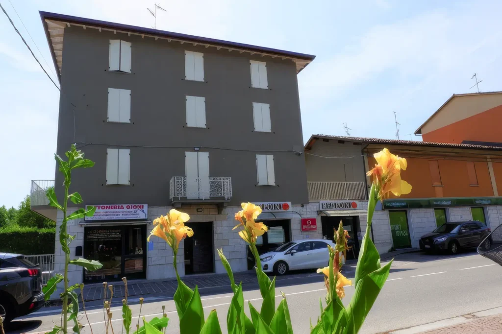 Edificio residenziale costruito da Impref in contesto urbano con area verde e fiori